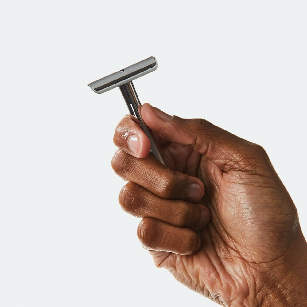 A man holding the Bevel double edge safety razor