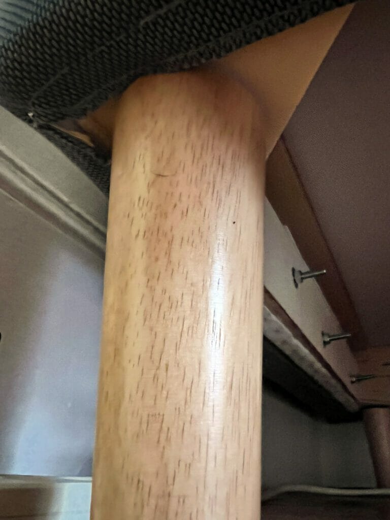 A leg after being installed, from the point of view of looking up from the floor