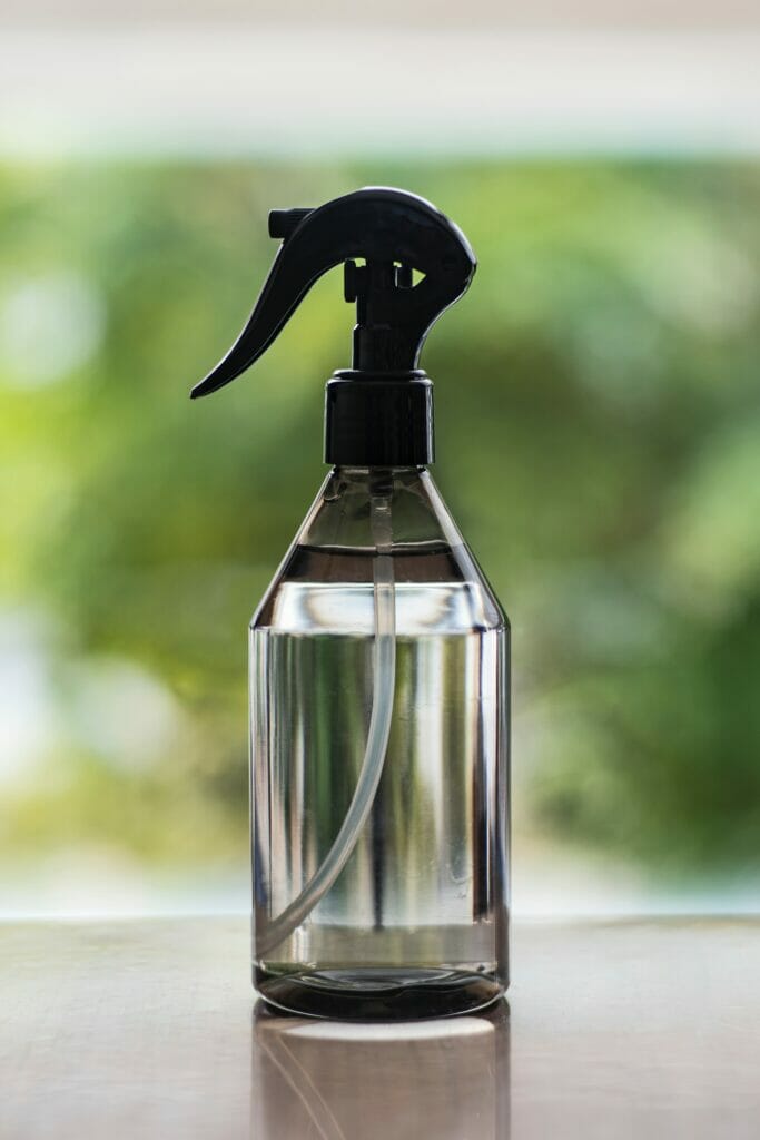 A clear glass spray bottle