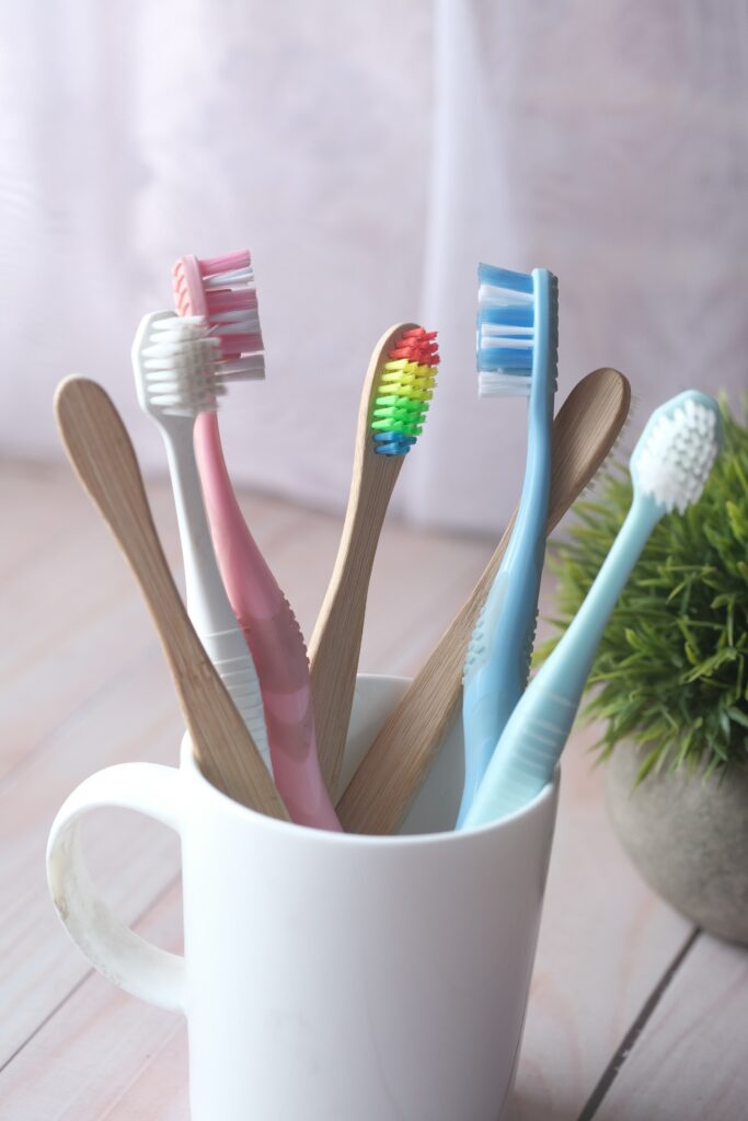 A bunch of old toothbrushes in a mug